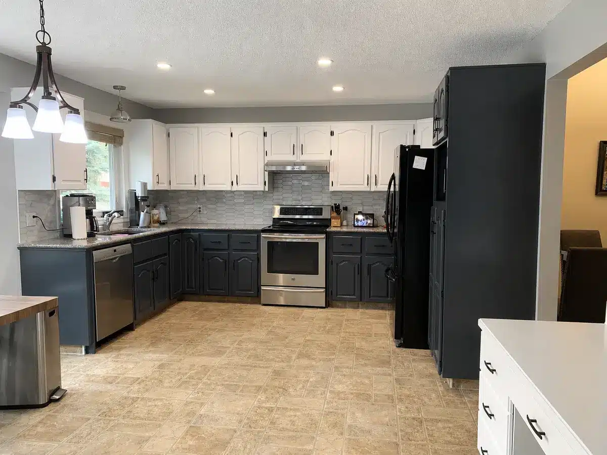 Kitchen cabinets painted white and charcoal with a smooth sprayed finish