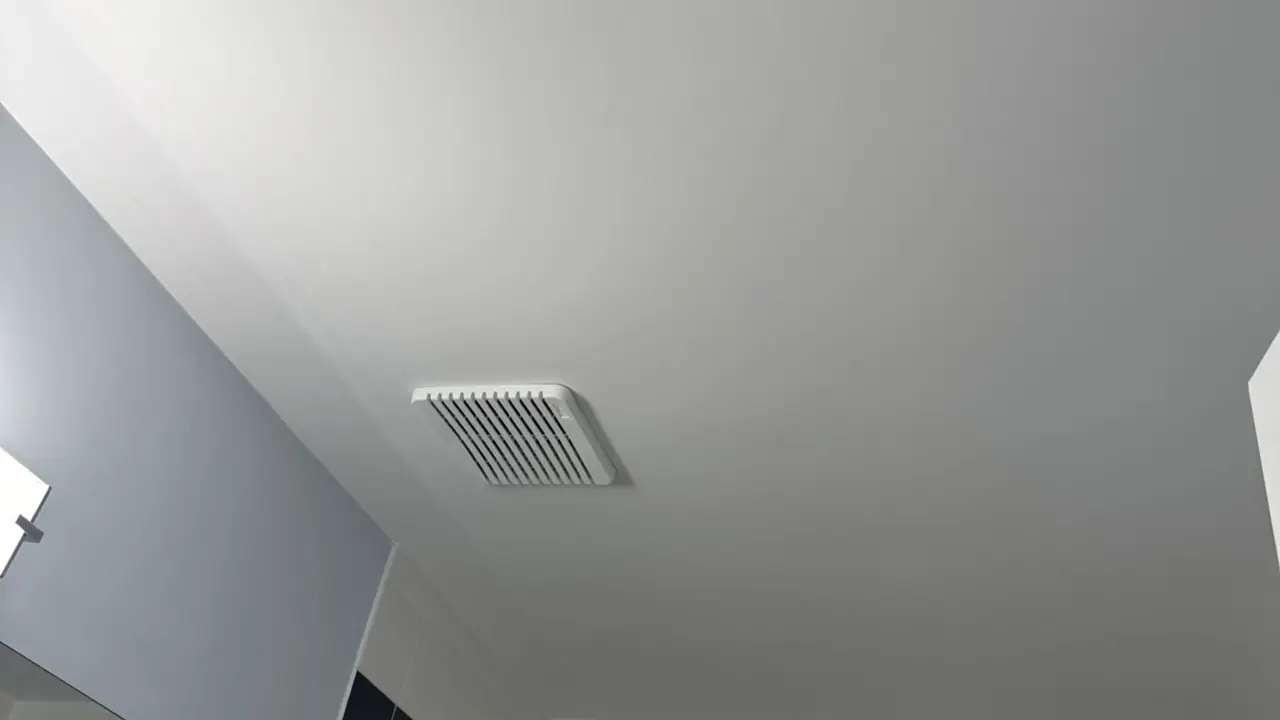 Smooth white bathroom ceiling in Signal Hill after repairs and painting